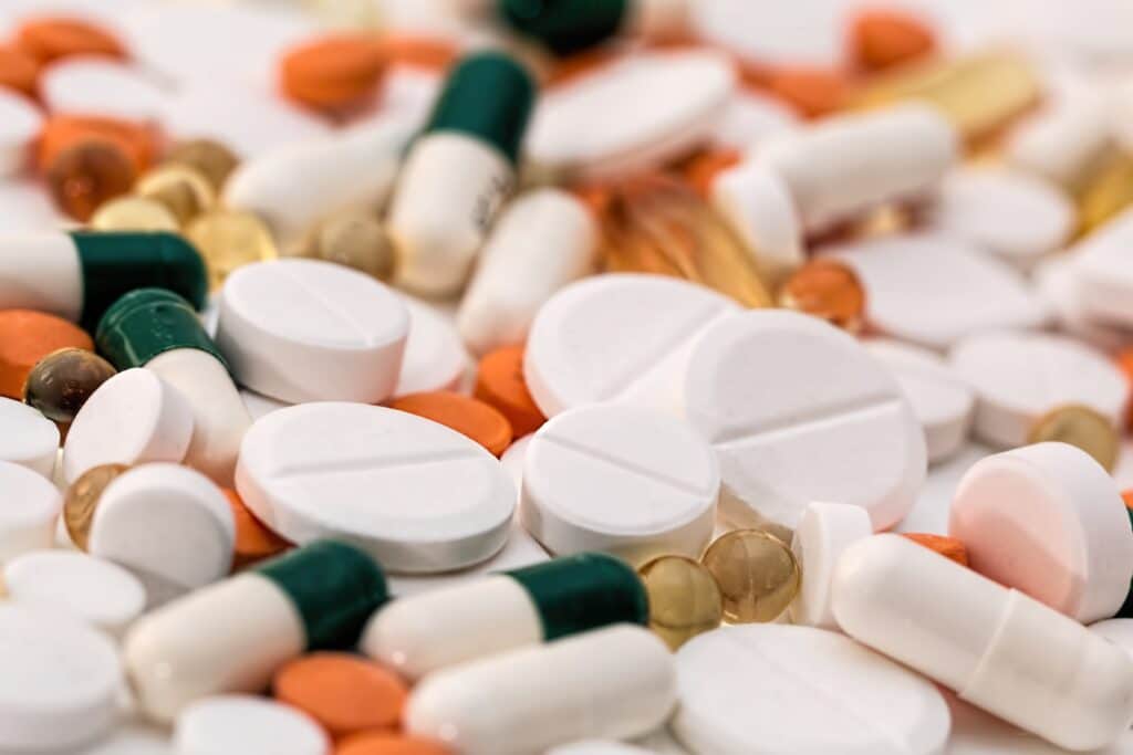 close up image of green, white and orange pills