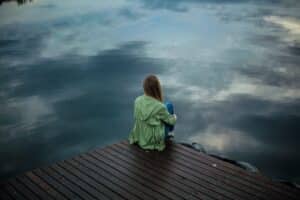 girl sitting on boat dock