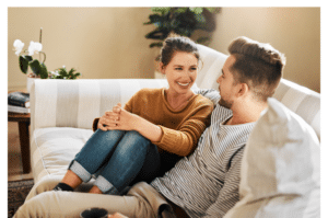 a couple on the couch talking about healthy relationships in recovery